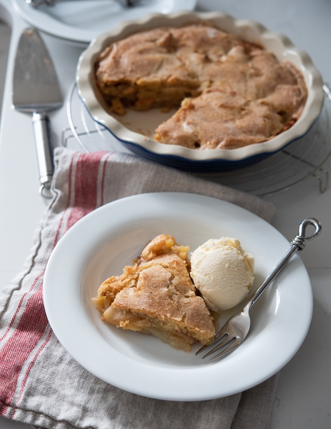 A slice of crustless apple pie served with vanilla ice cream.