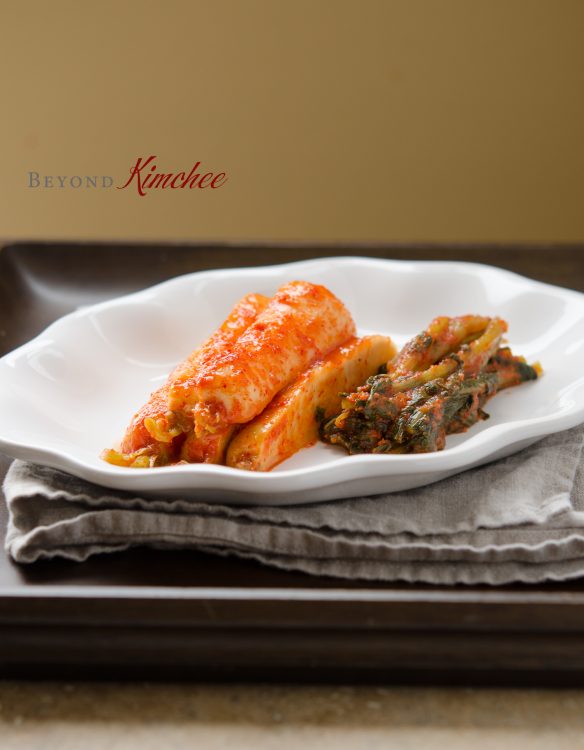 Well fermented bachelor (ponytail kimchi) is cut up and served on a plate.