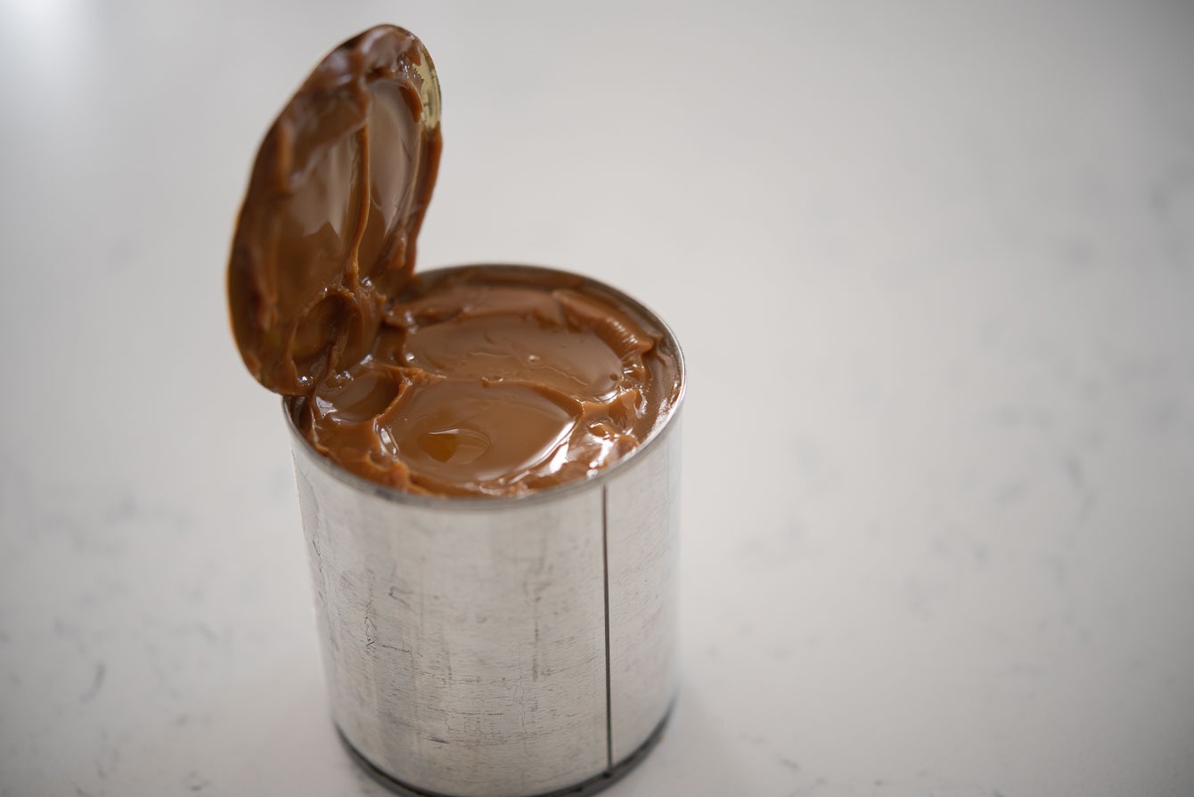A can of sweet condensed milk turned into dulce de leche