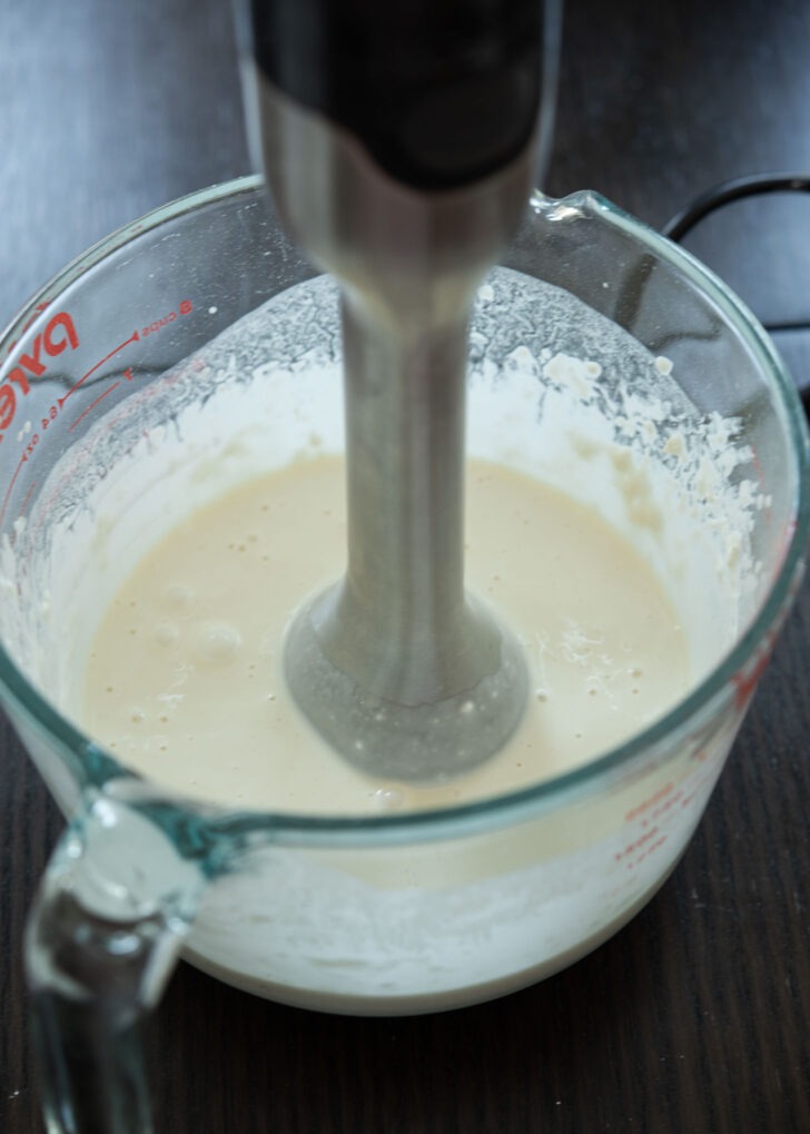 Immersion blender mixing the bungeoppang batter.