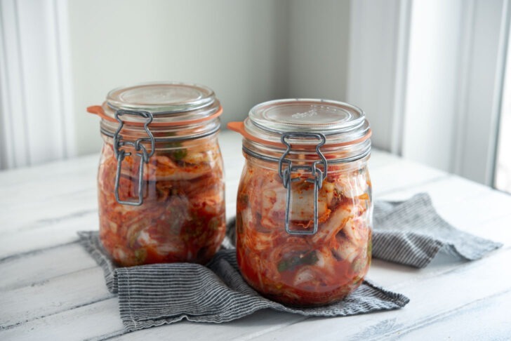 Cabbage kimchi is stored in two glass jars and getting ready to ferment.