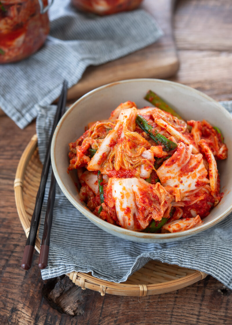 A top view of cabbage kimchi in a bowl.