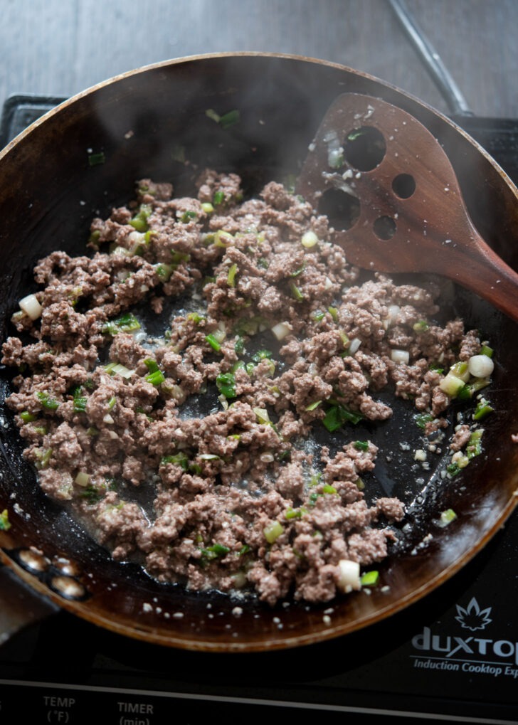 Ground beef browned in a skillet to make Korean gochujang noodles with beef.