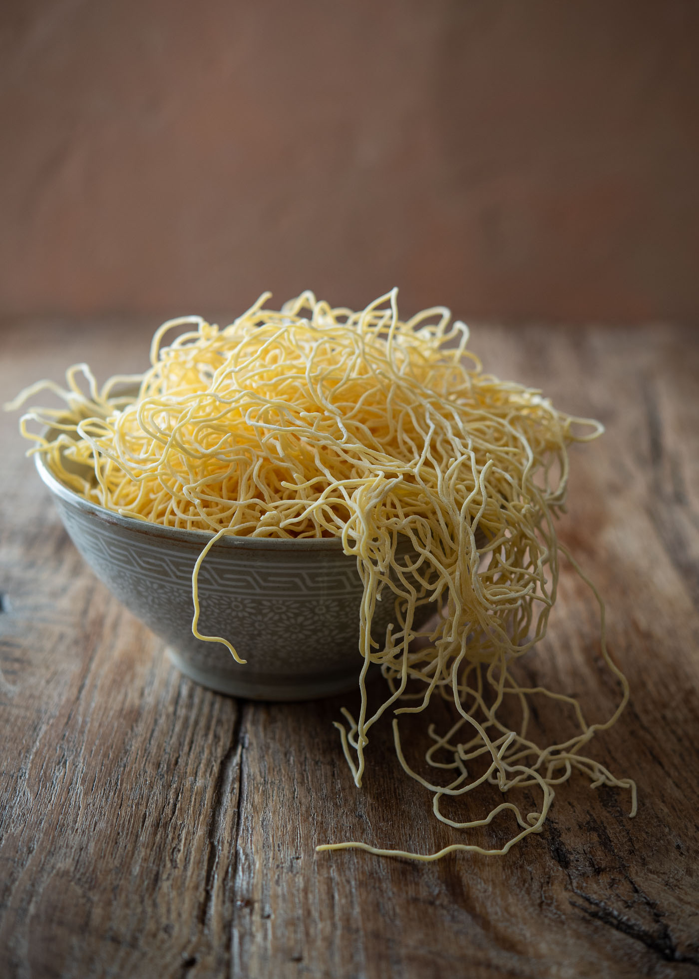 A bowl filled with Hong Kong style egg noodles.