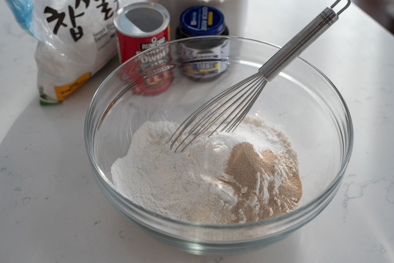 Mix flours and yeast in a bowl to make hotteok dough.