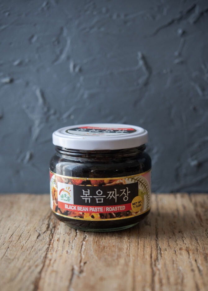 A jar of pre-roasted Korean black bean paste is placed.