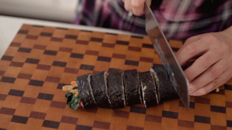 Slicing kimbap (Korean seaweed rice roll).