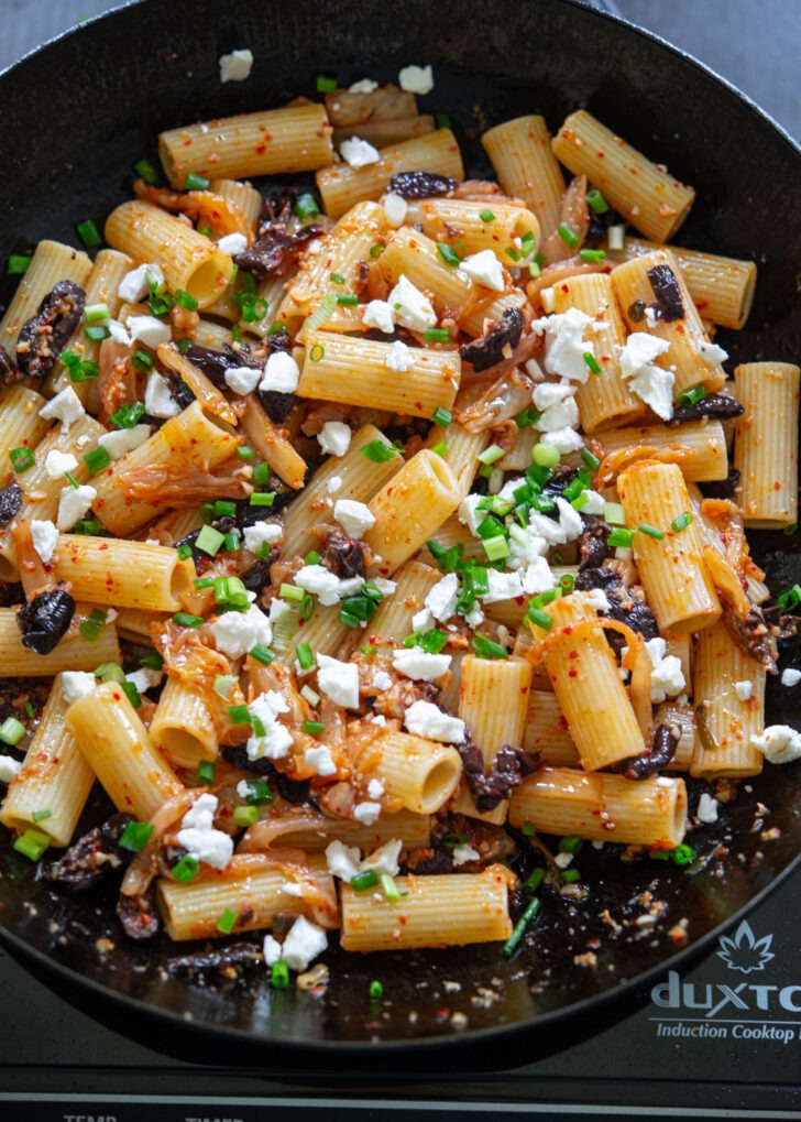 Feta cheese and green onion are added to kimchi olive pasta