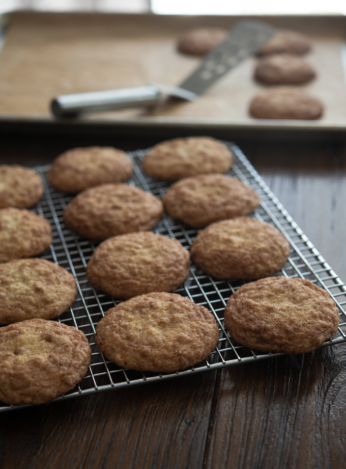 Freshly bake oatmeal snickerdoodles are cooling on a rack