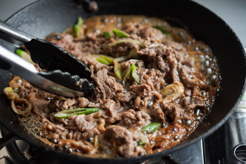 Sizzling Korean BBQ Beef in a skillet.