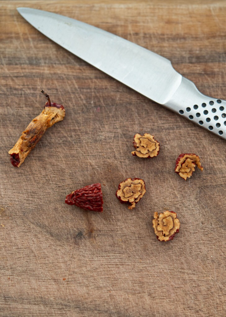 Rolled jujube is sliced off with a knife creating a tinny floral pattern.