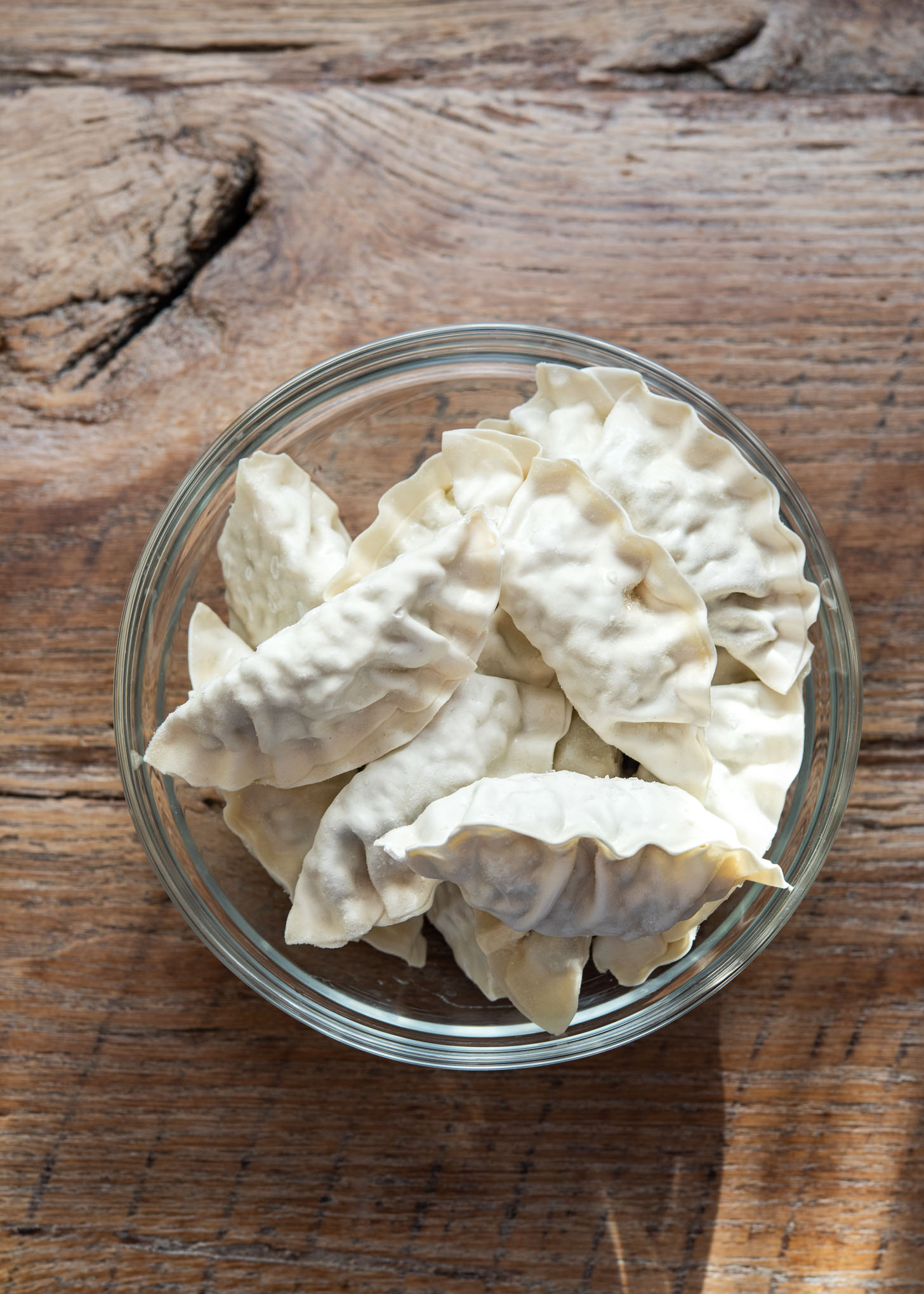 Frozen dumplings are in a bowl.