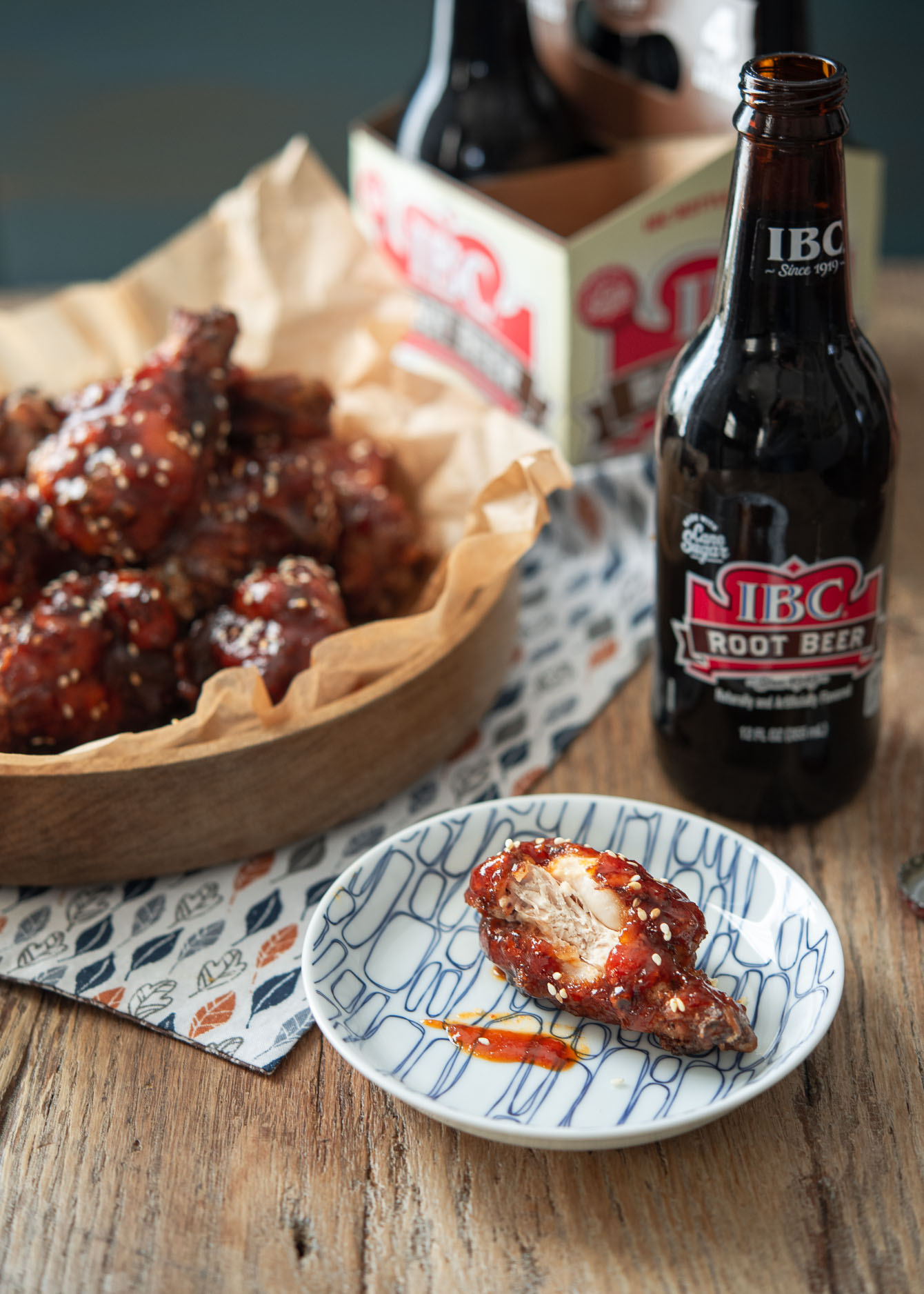 A piece of Korean fried chicken wing with root beer.