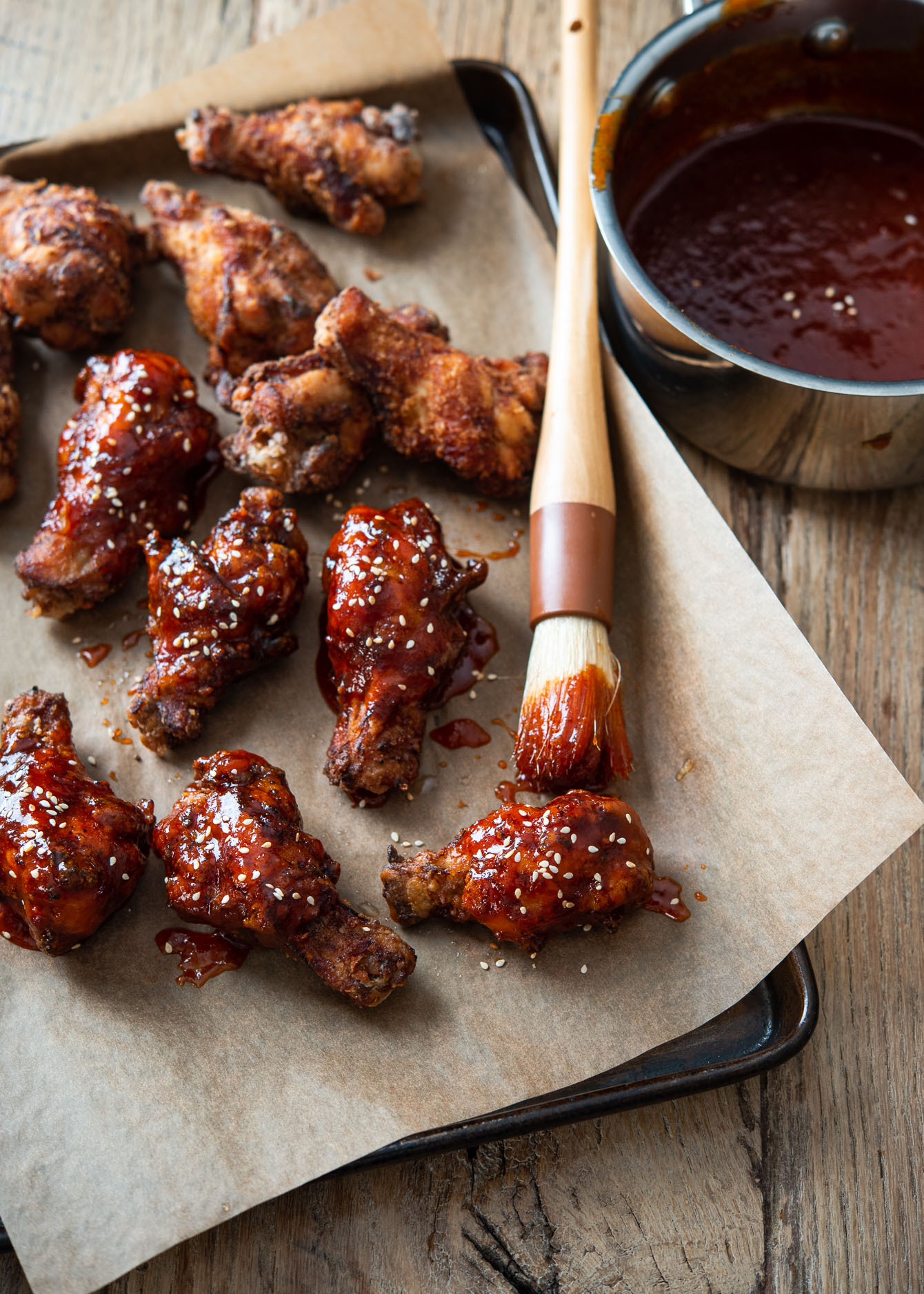 Deep-fried Korean fried chicken wings brushed with sweet and spicy gochujang sauce. 