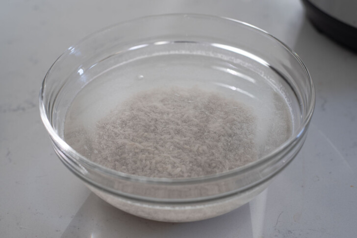 Fermented rice soaking in a bowl of water.