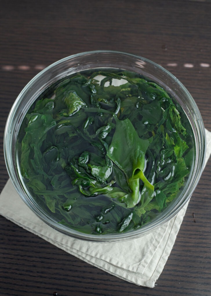 Dried seaweed rehydrating in a bowl of water.