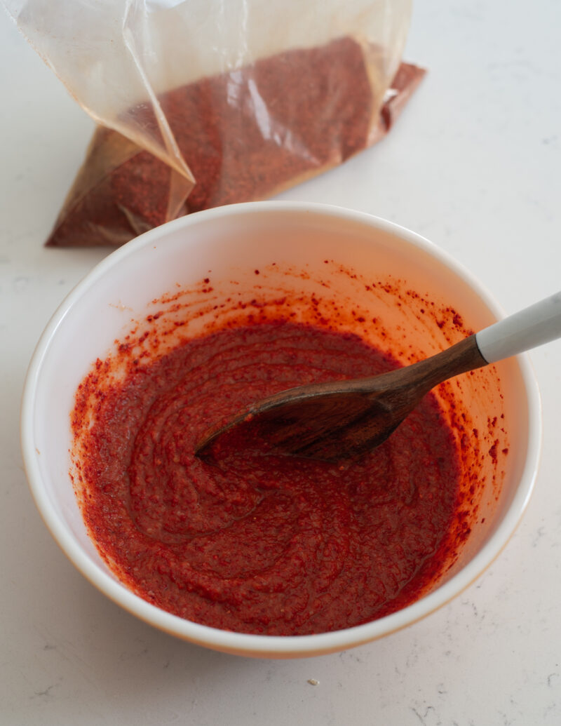 kimchi paste made in a mixing bowl with Korean chili flakes