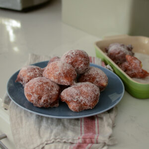Malasadas is famous Portuguese donuts. Simple yeast dough is deep fried, then coated with sugar.