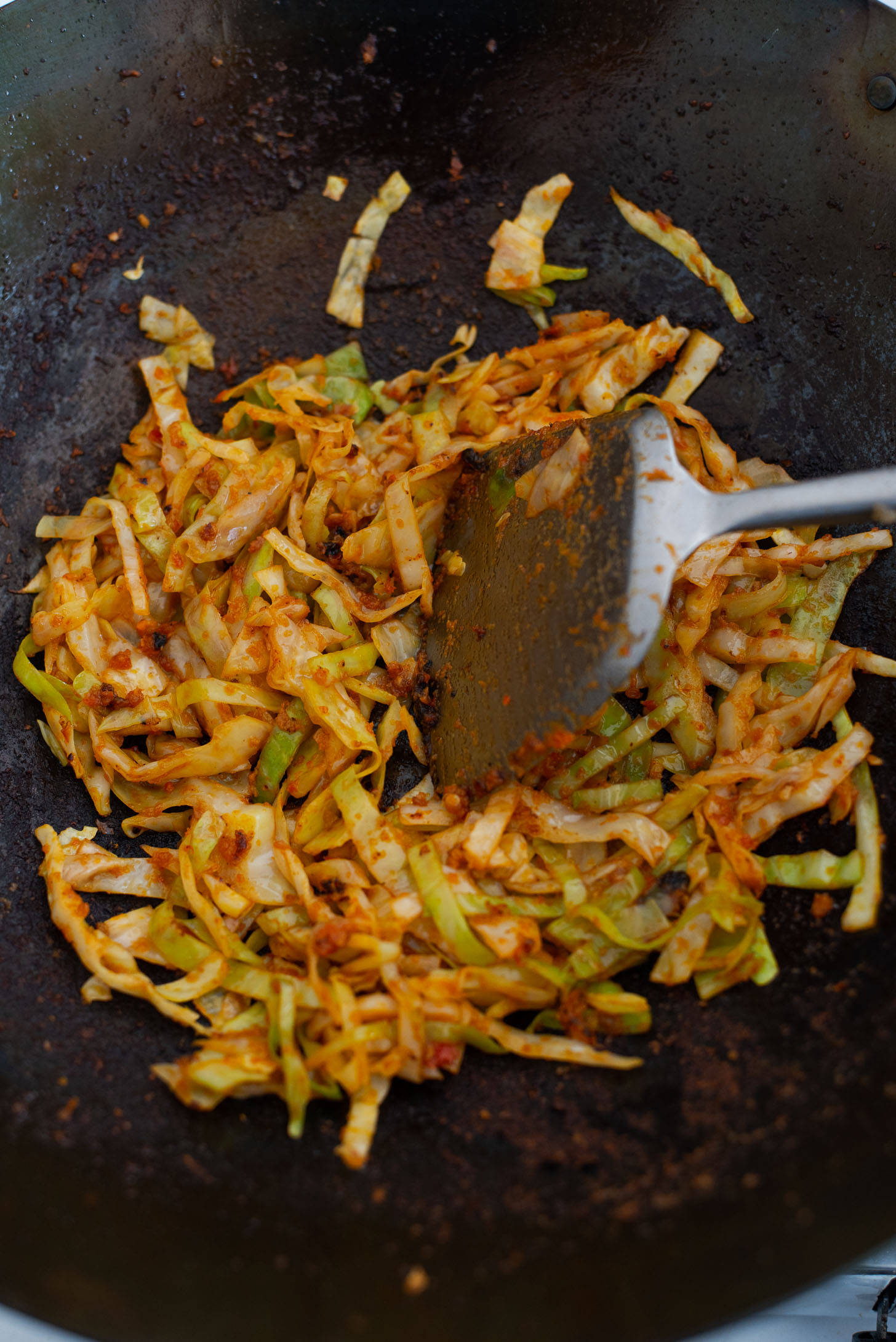 Cabbage is stir fried in chili garlic puree to make Nasi Goreng,