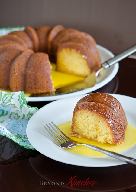 A slice of orange cake is served with luscious orange sauce.