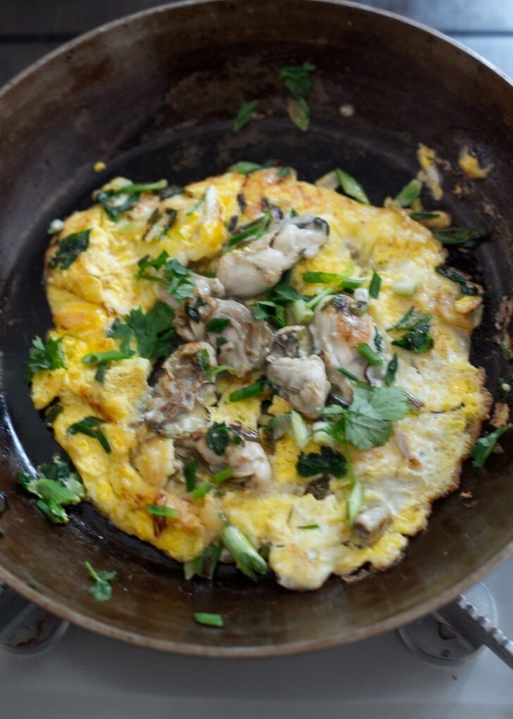 Oyster omelette garnished with cilantro.