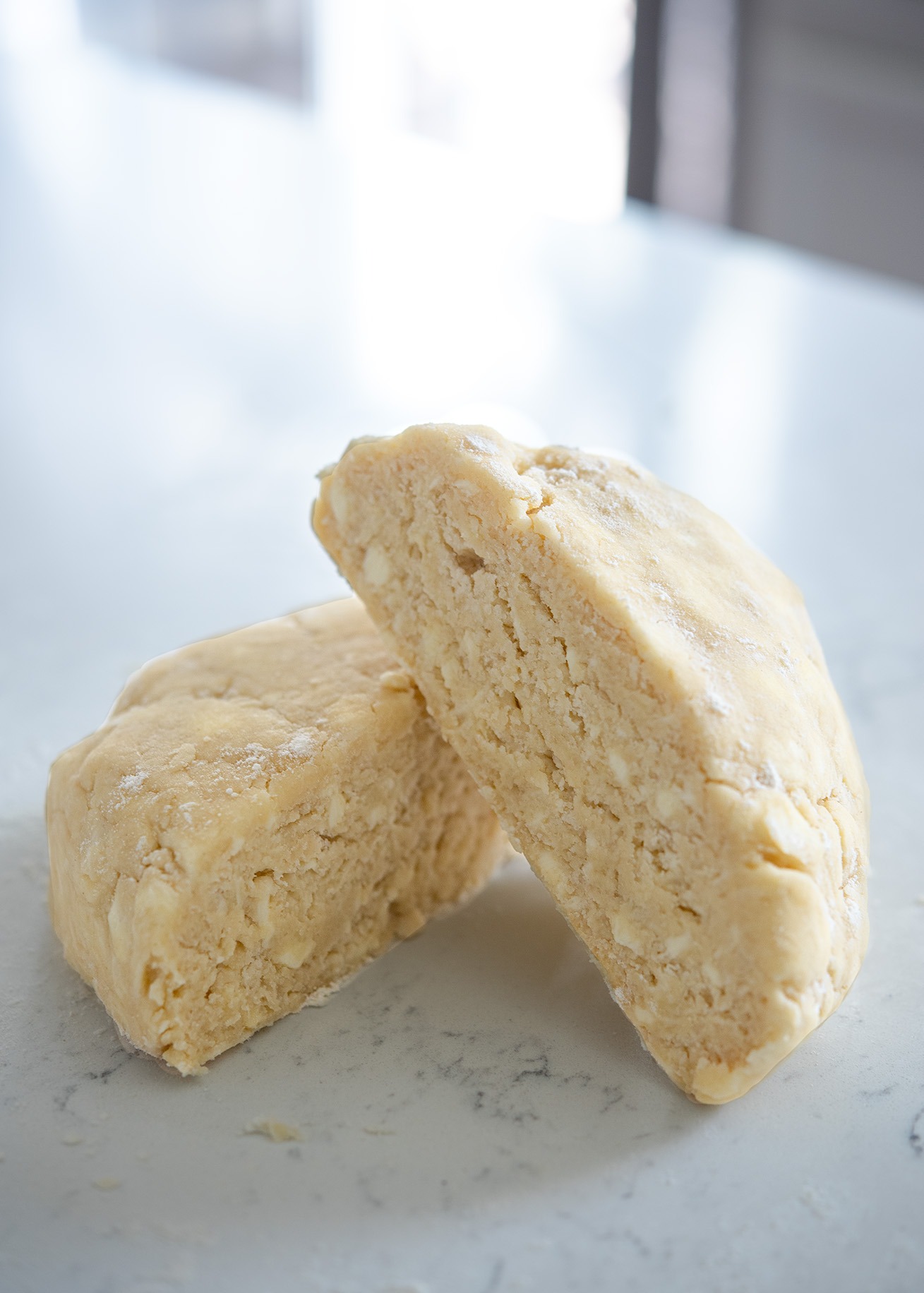 Lard and butter pie crust dough is showing its fat pieces inside the dough