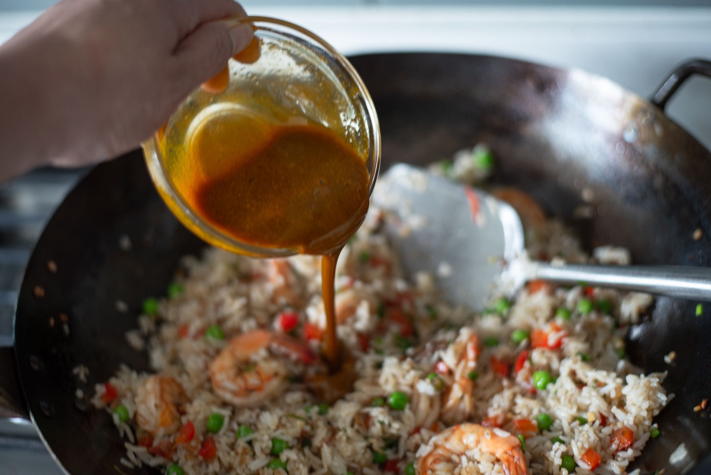Pineapple fried rice sauce is added to the rice mixture to season.