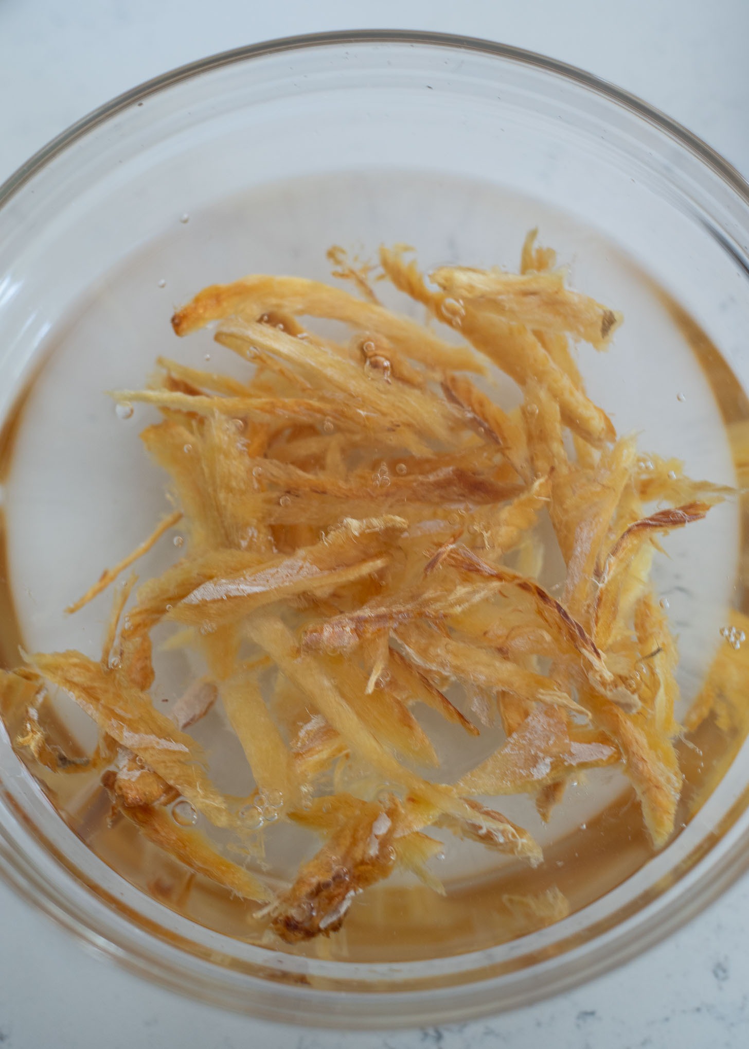 Soak dried pollock in a bowl of water to moisten.