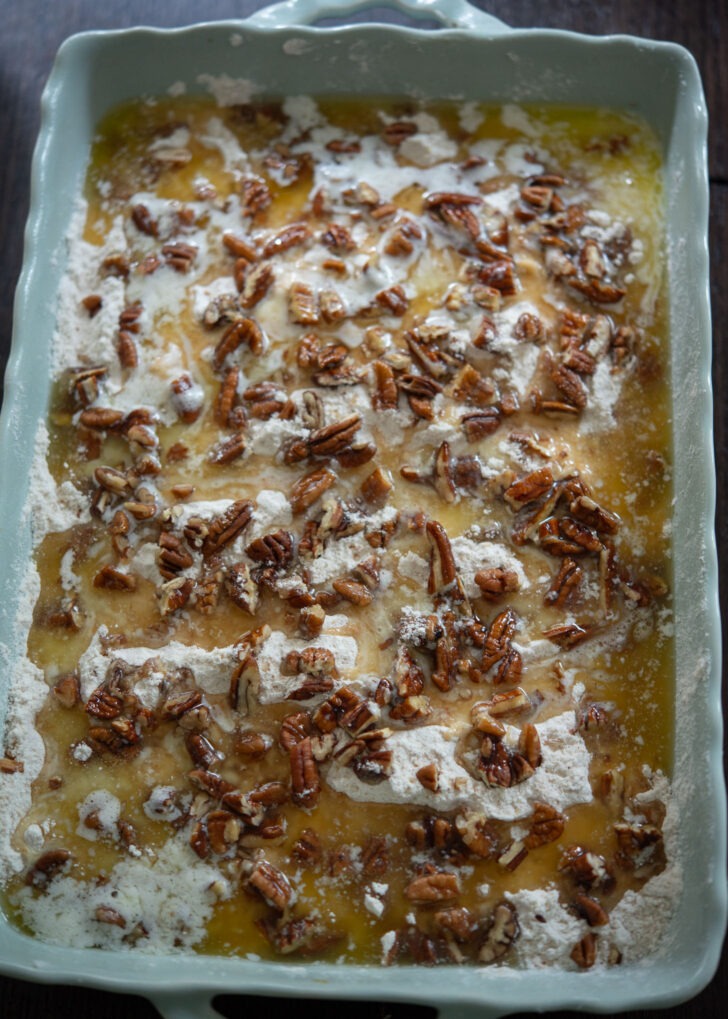 Dry cake mixture, chopped pecan, and melted butter on top of pumpkin filling.