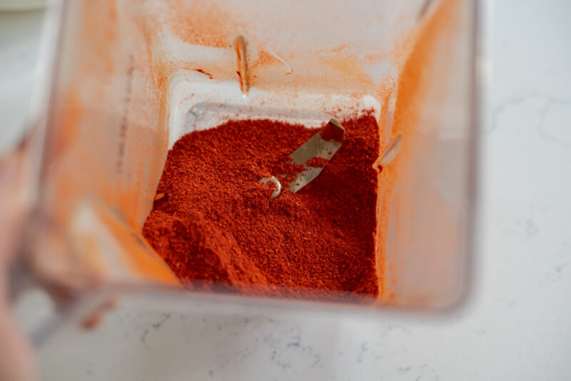 Korean chili flakes are processed in a blender to turn into fine chili powder.