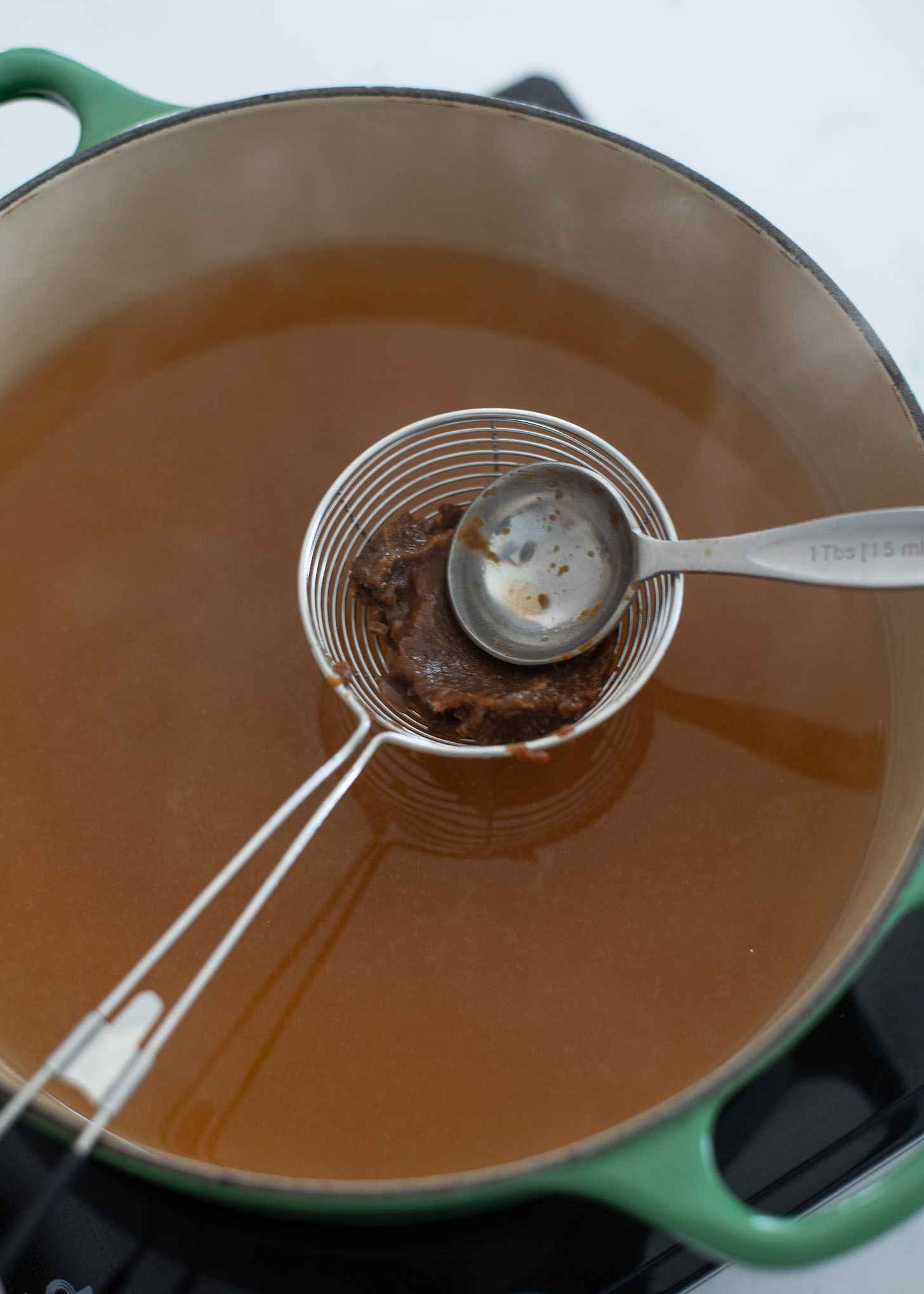 Korean soybean paste is smeared into seafood stock to make seaweed egg drop soup