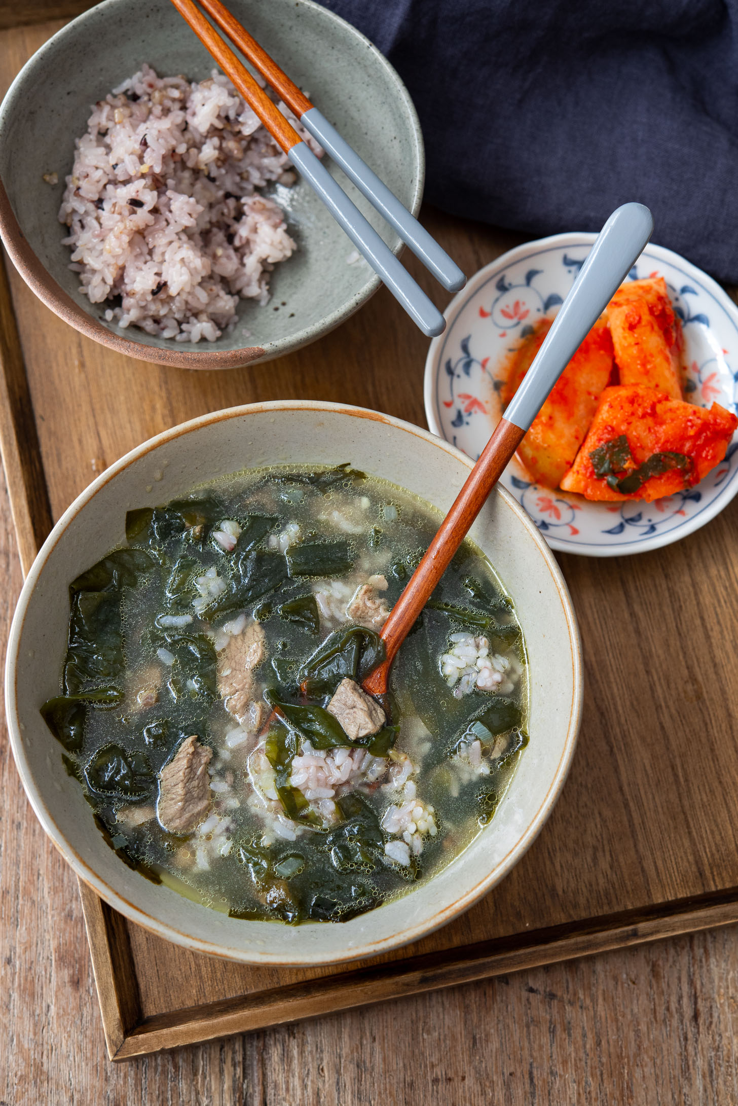 Rice is added to a bowl of miyuk guk, Korean seaweed soup.