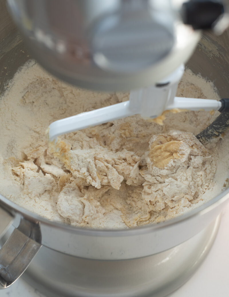 Dried ingredients are added to the creamed mixture in a stand mixer with a paddle attachment.