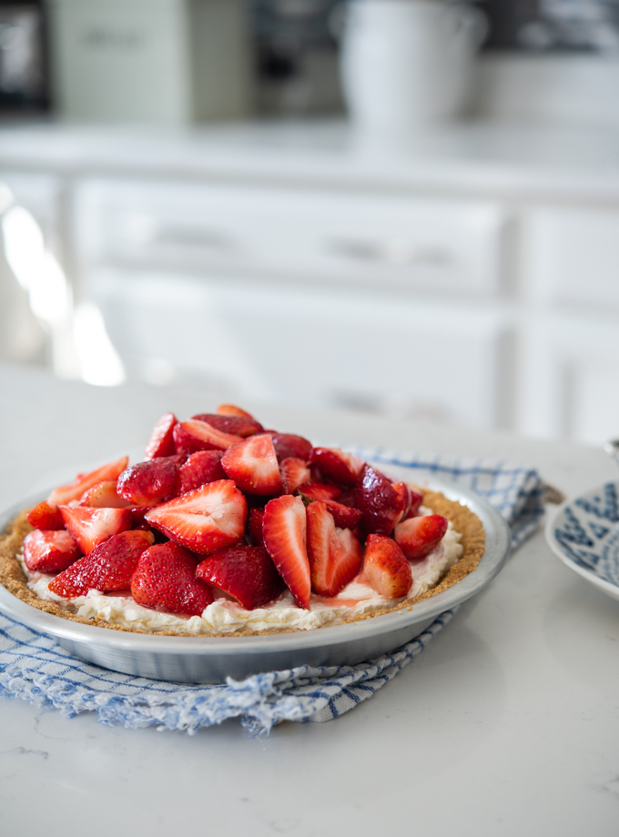 Strawberry mascarpone pie with fresh strawberries in a graham cookie crust.