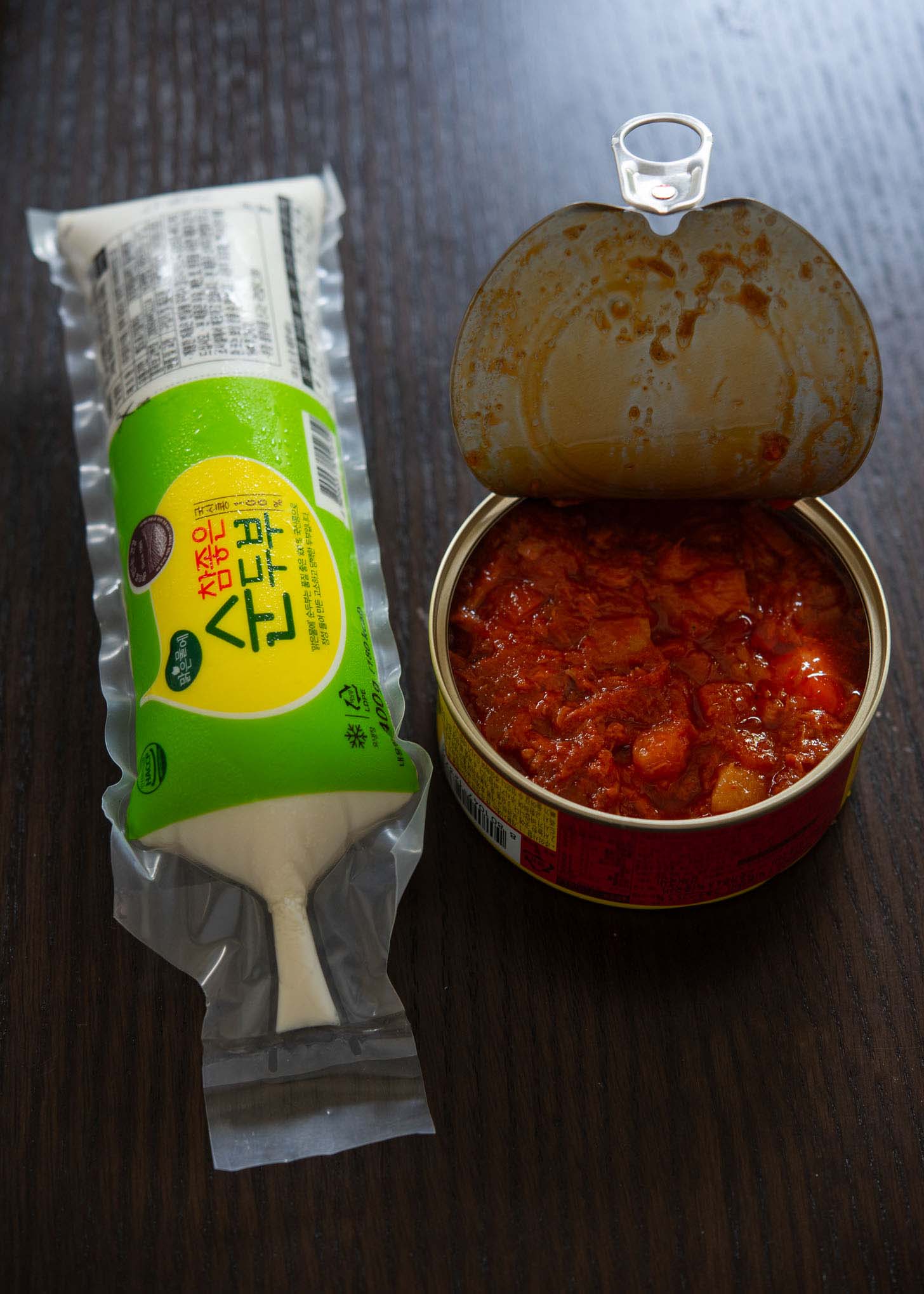 A tube of silken tofu and Korean hot pepper tuna in a can.
