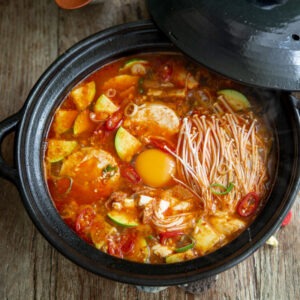 Sundubu jjigae (spicy Korean tofu soup) made with canned tuna in a pot.