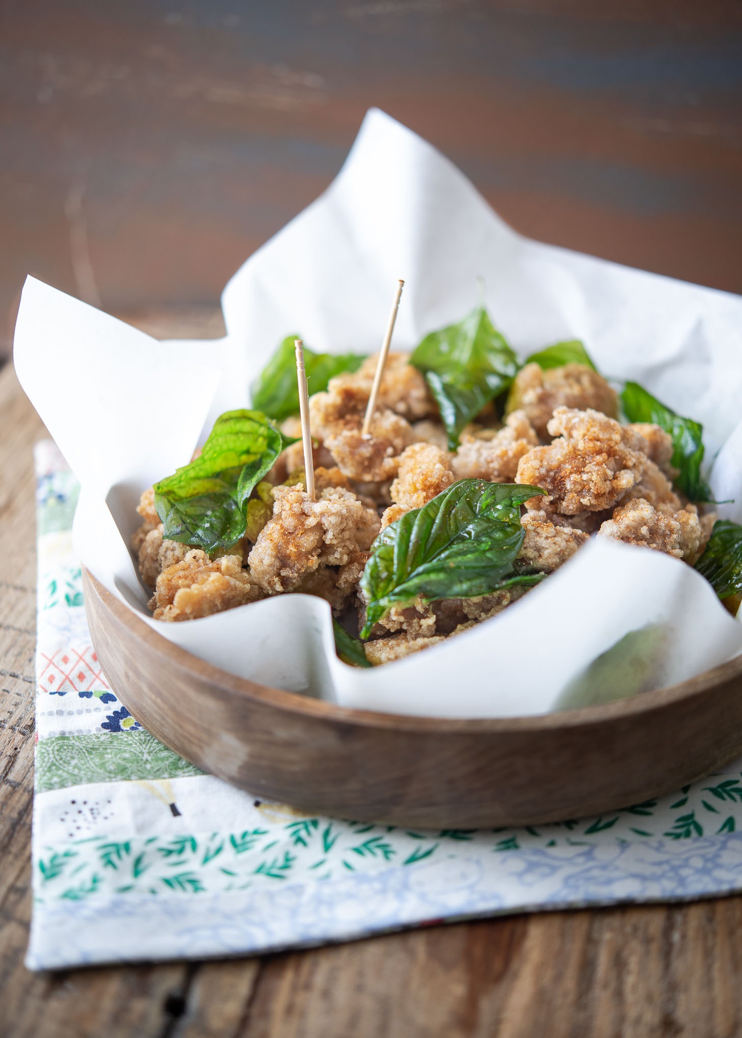Taiwanese popcorn sized fried chicken garnished with fried Thai basil.