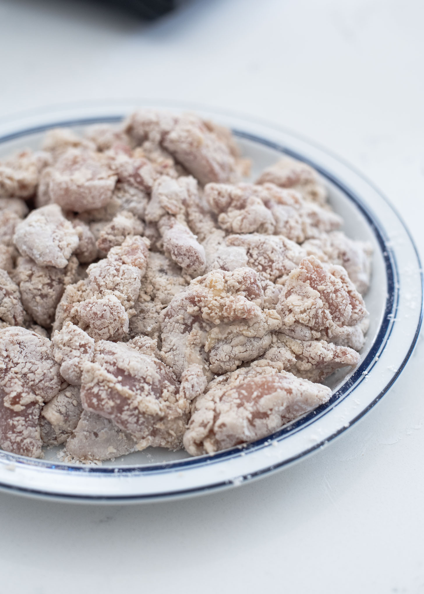 Chicken pieces coated with coarse sweet potato starch are ready for deep-frying.