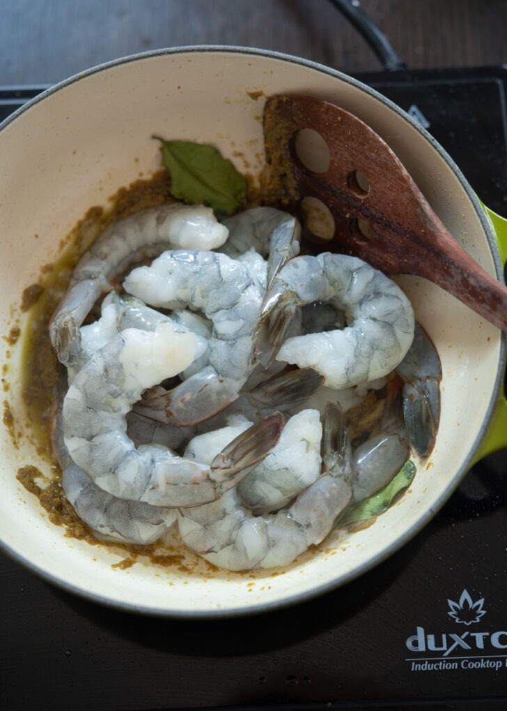 Raw shrimp, lemongress, kaffir lime added to green curry paste.