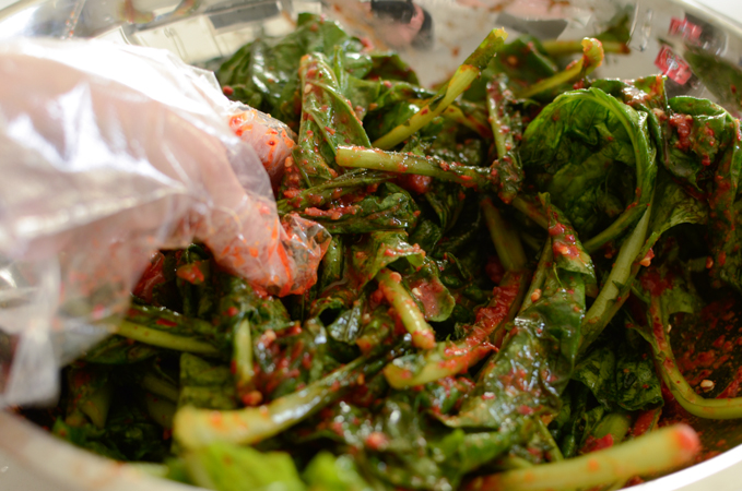 Turnip greens are hand tossed with kimchi filling.