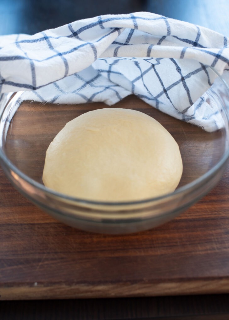 Korean twisted donut dough is formed to a ball and placed in a greased bowl to rise.