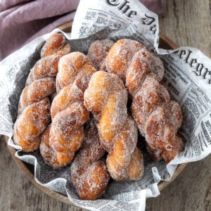 Cinnamon sugar coated Korean twisted donuts are served in a bowl.
