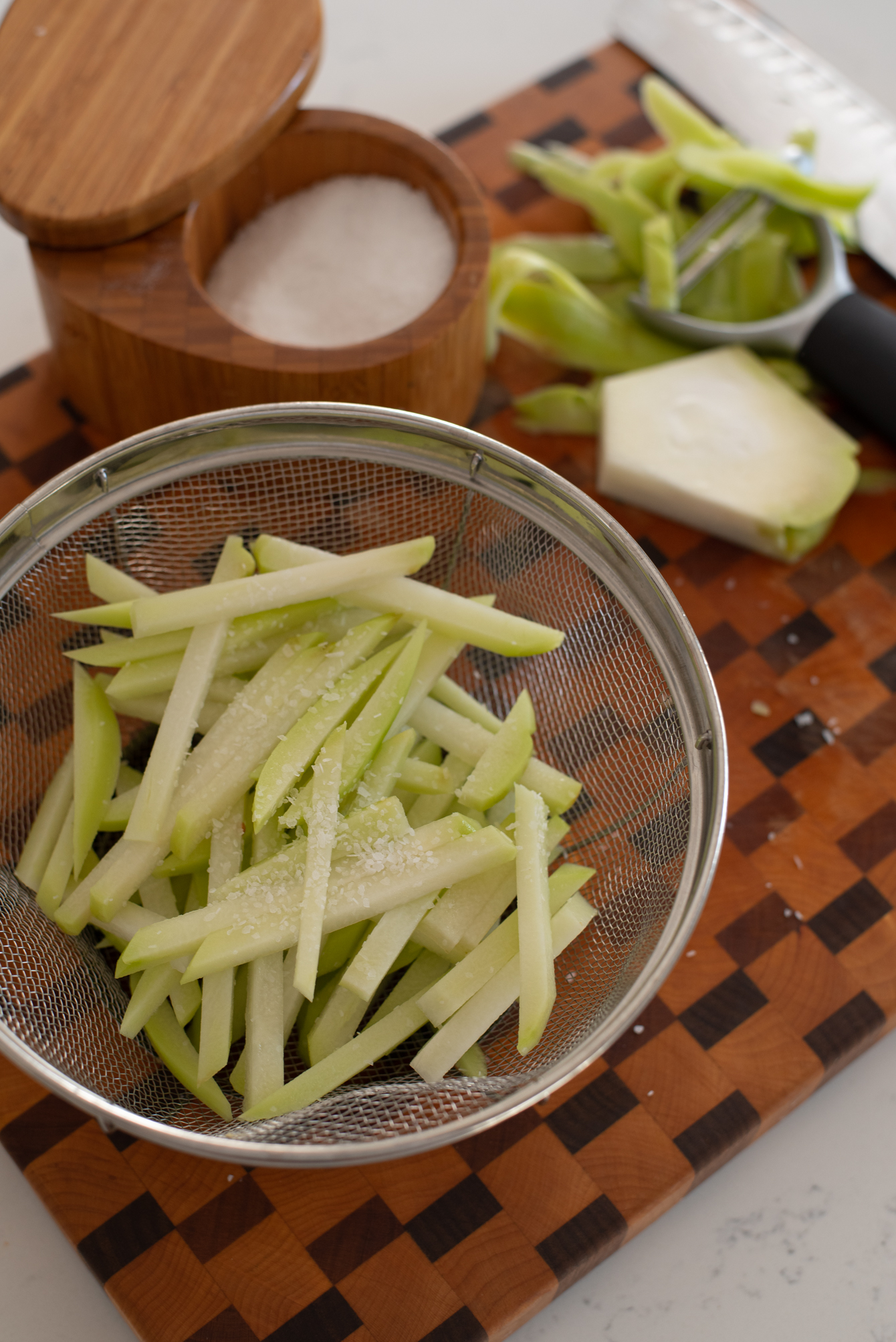 Sliced chayote vegetable needs salt to get rid of sliminess.