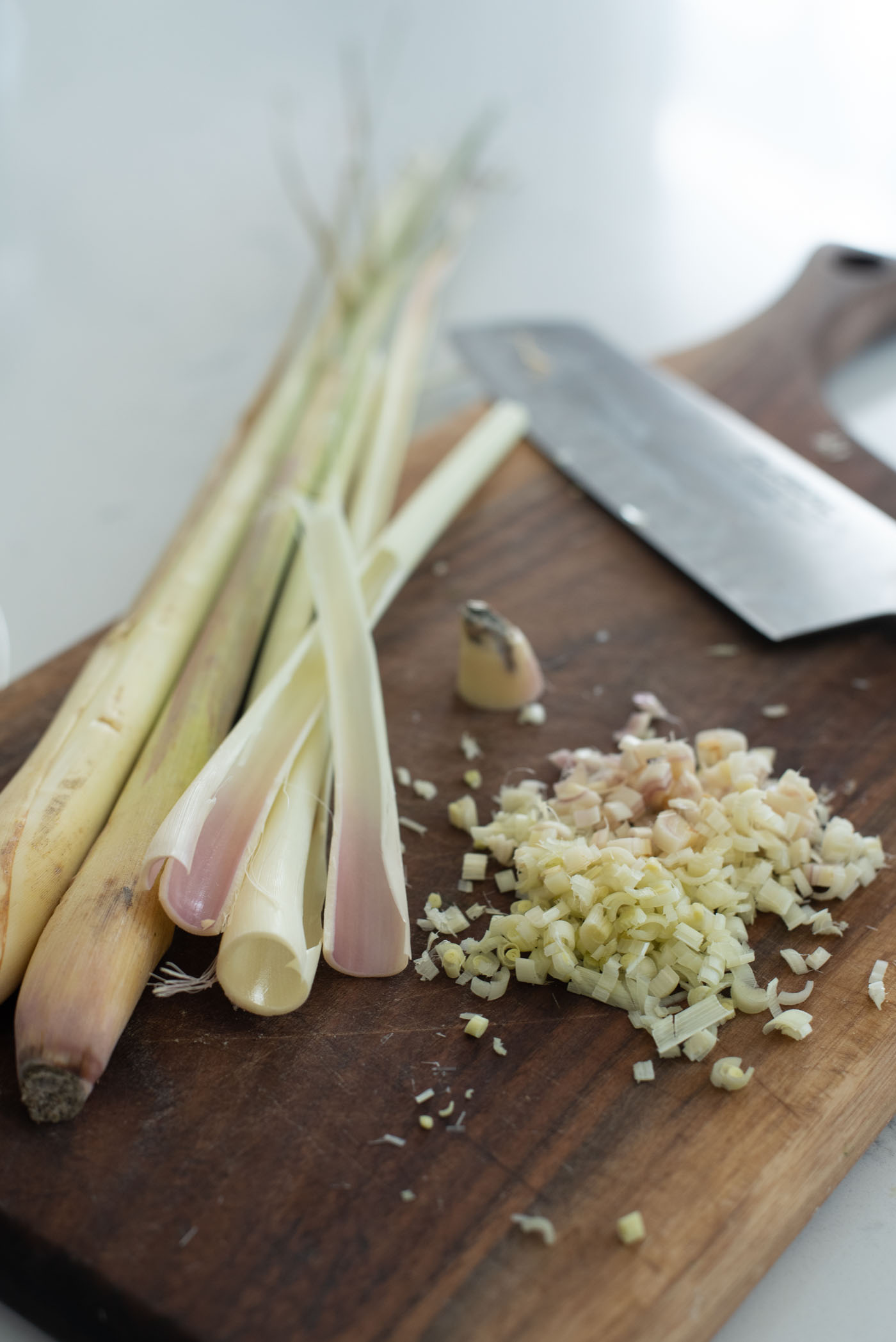 Outer layers of lemongrass are peeled off and the white core part is finely minced